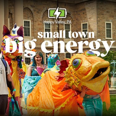 Colorful parade featuring large, vibrant puppets and performers in Happy Valley, PA. Text overlay reads "small town big energy."