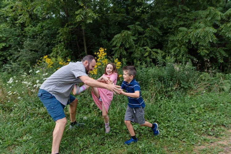 It's National Travel & Tourism Week! 10 Father playing with children in field