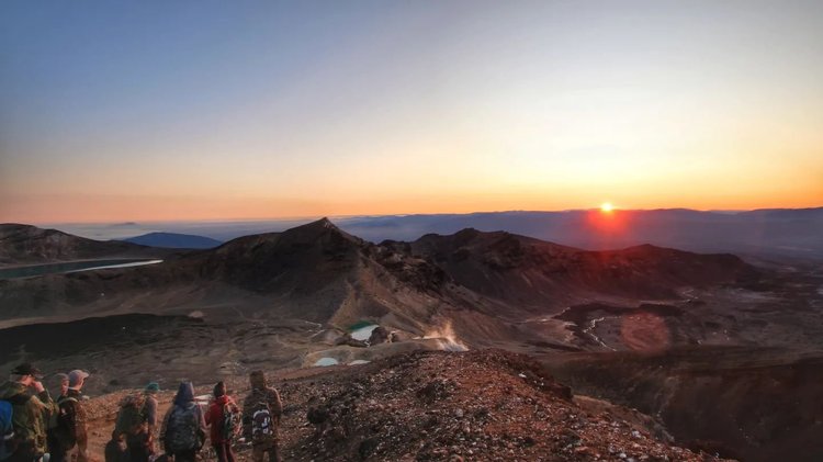 Photo by petbunny, caption reads: Labour weekend hike:

Waking up at 2am for this view. Kinda refreshing to walk in the dark n luckily the weather was great for the sunrise view. Total of 50km completed, 1050m elevation gained just on day 2
.
.
#tongarironortherncircuit #nzwalks #newzealandgreatwalks #hikemoreworryless #solofemaletraveler #sunrise #sunrisephotography #volcanoes #naturephotography #newzealandhiking #tongarironationalpark #tongariroalpinecrossing #wanderlust #earthpixnz #travelnewzealand #adventurehike #sunriselover #landscape_captures tongarirocrossing lovetauponz newzealandtrails home.grownnz nzgeo