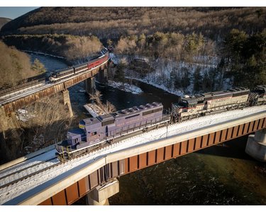 Photo by mike_stanislaw, caption reads: When the stars align. 
Reading Blue Mountain & Northern’s daily freight holds on the Nesquehoning bridge while in the background the 3pm Lehigh Gorge excursion train backs it way to Jim Thorpe PA. 
.
.
.
#rbmn #nrff #lgsy #lehighgorgescenicrailway #jimthorpe #lehighriver #readingandnorthern #readingandnorthern2102 #readingandnorthernrailroad #railroad #carboncounty